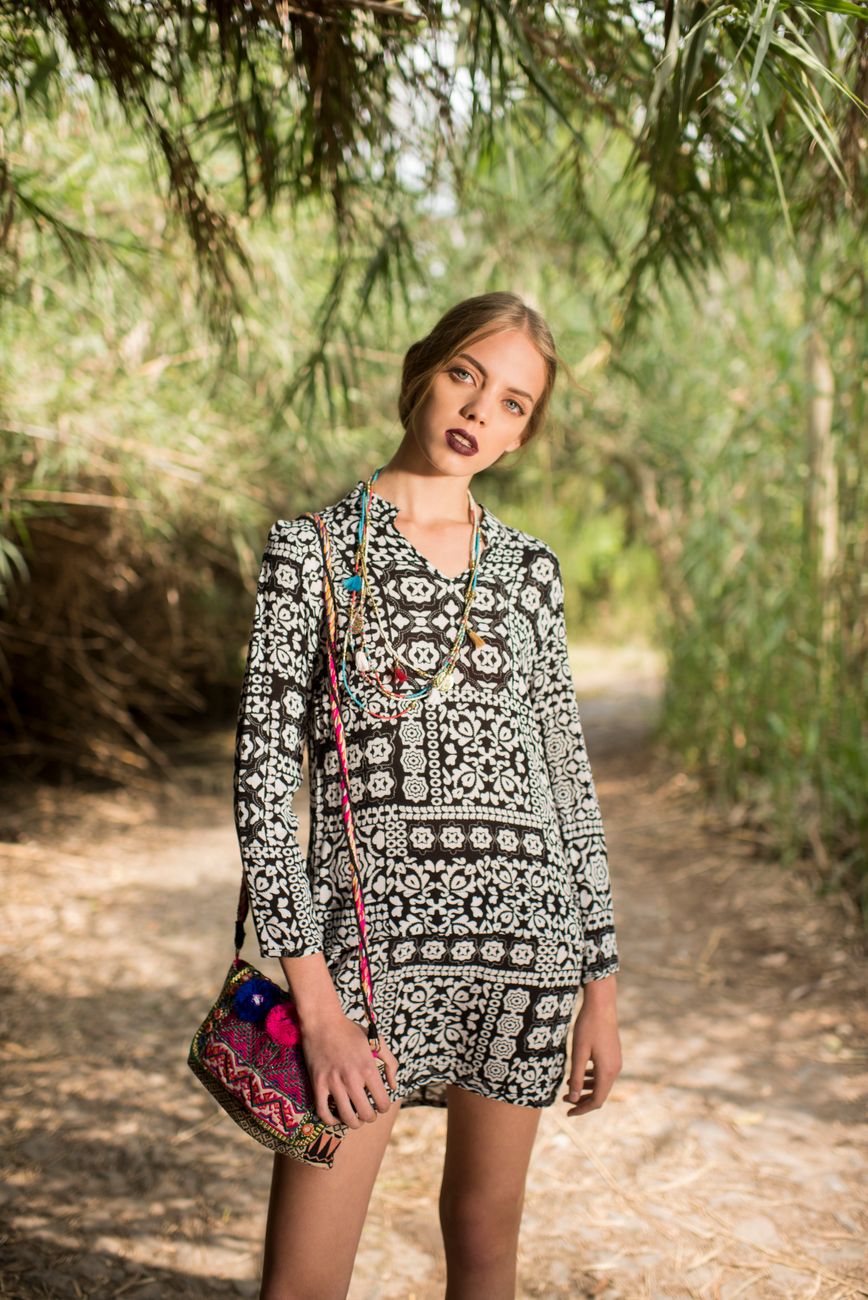 woman standing in park alley